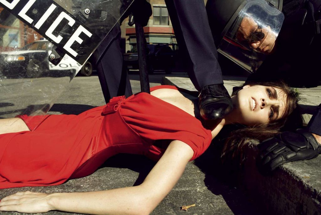 Editorial photo of a model dressed in red arrested by police