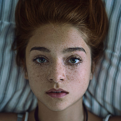 Image by Beautiful portrait of a girl with freckles lying down on a pillow. The image was taken on October 22, 2014 by maximilianmair. This photo is licensed under common creatives CC2 for free personal and commercial usage. Please refer to the link below for proper license description.